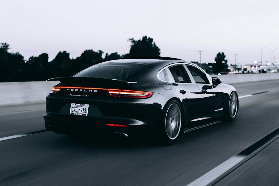 Black Porsche Panamera driving on a highway